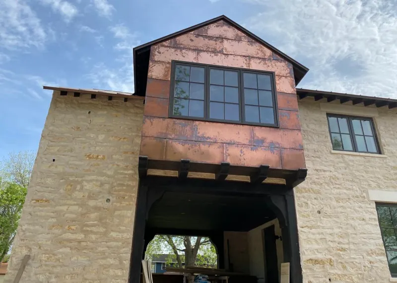 Copper metal panel facade on a stone building for Roof Repair in Centreville